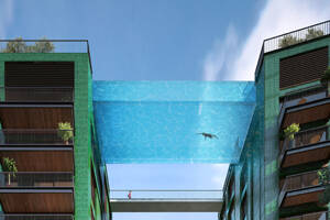 A swimming pool suspended between two buildings